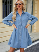 Light blue tiered long sleeve denim dress with button front and side pockets in soft denim material