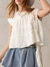 White tiered cap sleeve blouse with ruffled sleeveless design paired with delicate gold star necklace
