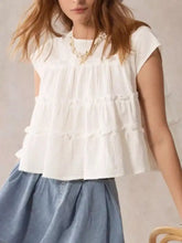 White tiered cap sleeve blouse with delicate ruffles made of soft lightweight fabric for elegant wear