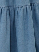 Soft blue denim midi skirt with gathered waistband and gentle pleats in tiered denim midi skirt style