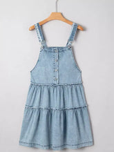 Light blue denim dress with tiered ruffles and button front made from denim fabric with machine wash care instructions