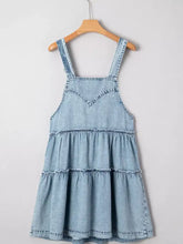 Light blue denim dress with tiered flowy design, thin straps, v-neckline, and easy machine wash care instructions