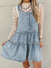 Light-wash denim dress with tiered ruffles and button front designed for easy machine wash care instructions