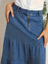 Blue denim maxi skirt with front zipper and tiered ruffle hem made of durable denim fabric