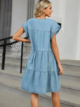 Light blue denim dress with tiered round neck short flutter sleeves and ruffle details in soft denim fabric