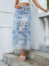 Light-wash denim patchwork skirt with tiered ruffle sheer layers and beaded drawstring waistband