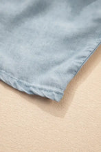 Light blue denim maxi skirt with tiered wash design and elastic waist featuring soft faded texture and stitched hem