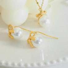 Titanium steel bow drop earrings with 18k gold-plated pearl accents
