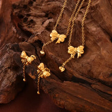 Titanium steel bow earrings and matching gold necklaces with heart accents