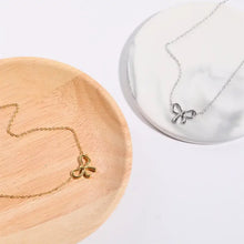 Titanium steel bow pendant necklace with delicate gold chain
