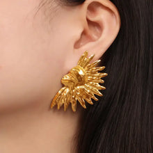 Gold-plated titanium steel sunflower earring on ear