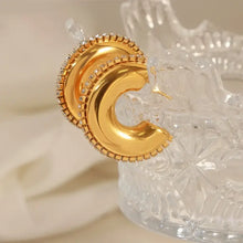 Titanium steel inlaid zircon C-hoop earrings with gold-toned hoops and clear rhinestones