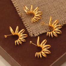 Four shiny gold titanium steel irregular shape ear cuffs with spiral design