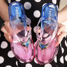 Clear toe post flats slippers with pink soles and blue fox-head details