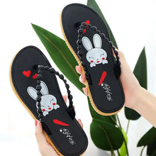 Pair of black toe post flats slippers with white bunny and red carrot design