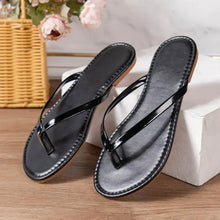Pair of black patent leather toe post flats slippers with light brown soles