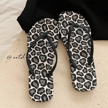 Pair of leopard print toe post flats slippers with black straps