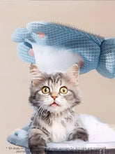 Light blue mesh-gloved hand holds Touch Pet Hair Remover Glove with pink paw accents