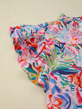 A vibrant pink blouse with tropical floral print, notched neck, and ruffled short sleeves for stylish wear