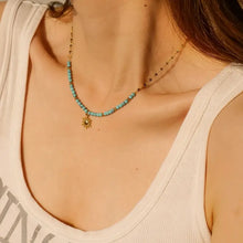 Turquoise beaded sun charm necklace with 18k gold-plated sun charm