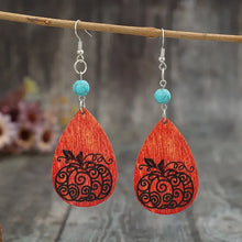 Turquoise wooden pumpkin teardrop earrings with carved design