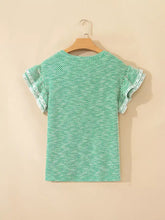 A mint green short sleeve blouse with twilled print lace trim and delicate ruffled short sleeve detailing
