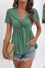 Green short sleeve blouse with twist knot v neck and front knot detail in lightweight fabric for casual wear