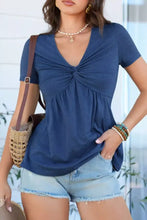 Blue short sleeve blouse with twist knot detail and v neck, ideal for casual and professional wear