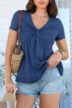 Navy blue short sleeve blouse with twist knot front detail made of soft flowing fabric for elegant wear