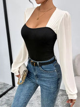 Two tone long sleeve black ribbed bodysuit with sheer white sleeves perfect for stylish layering