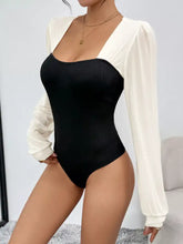 Black ribbed two tone long sleeve bodysuit with white sheer overlay for stylish layering and comfort