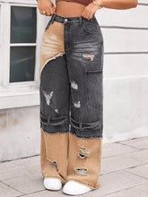 Two-tone ripped wide leg jeans in black and tan distressed denim with ripped details for a trendy look