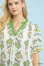 White blouse with abstract border print in vibrant green floral pattern and matching ruffled collar with puffed sleeves