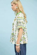 White blouse with vibrant green yellow and orange floral abstract border print ruffled sleeves and matching collar