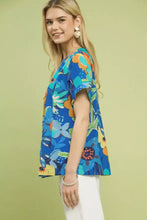 Blue short-sleeved Umgee abstract floral pleated blouse with vibrant orange teal and green accents in lightweight fabric