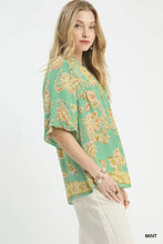 Umgee apricot floral mint-colored blouse with yellow and peach floral print featuring ruffled sleeves and v-neckline