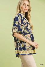 Navy blue umgee apricot floral boho blouse with short flutter sleeves and decorative yellow border at hem