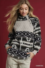 Charcoal sherpa pullover with high collar, aztec print oversized fit, quilted gray chest panel, and snap buttons front