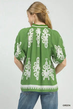Umgee boho print short sleeve top in green with white embroidered floral patterns and split neck detail