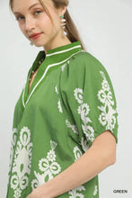 Green boho print short sleeve blouse with white floral embroidery and a high collar featuring a split neck design