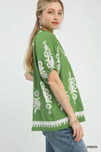 Green umgee boho print short sleeve top with split neck white embroidered floral patterns and decorative hem trim