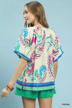 Umgee border print puff sleeve cream blouse with multicolored floral paisley print and decorative striped hem