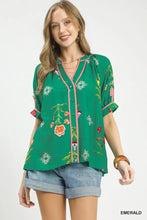 Emerald green umgee blouse with botanical print contrast, pink print contrast trim, and rolled sleeves