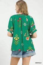 Emerald green umgee botanical print contrast trim button blouse with short sleeves and rolled cuffs