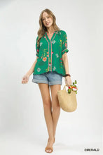 Emerald green umgee botanical print contrast trim button blouse with short sleeves and embroidered floral design