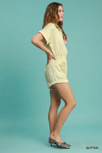 Woman in Umgee Button Down charmeuse romper, pale yellow charmeuse fabric