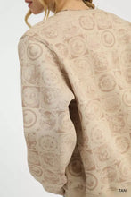 Beige tan umgee sweatshirt with a coin stamp print featuring vintage-style circular illustrations in muted brown tones