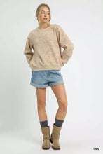 Tan oversized Umgee sweatshirt with subtle repeating coin stamp print pattern for casual wear