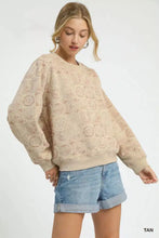 Tan oversized umgee coin stamp print sweatshirt with subtle repeating circular stamp print pattern on fabric
