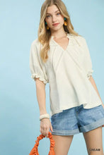 Cream-colored umgee cotton gauze ruffle top with lightweight fabric delicate ruffled sleeves and embroidered v-neckline